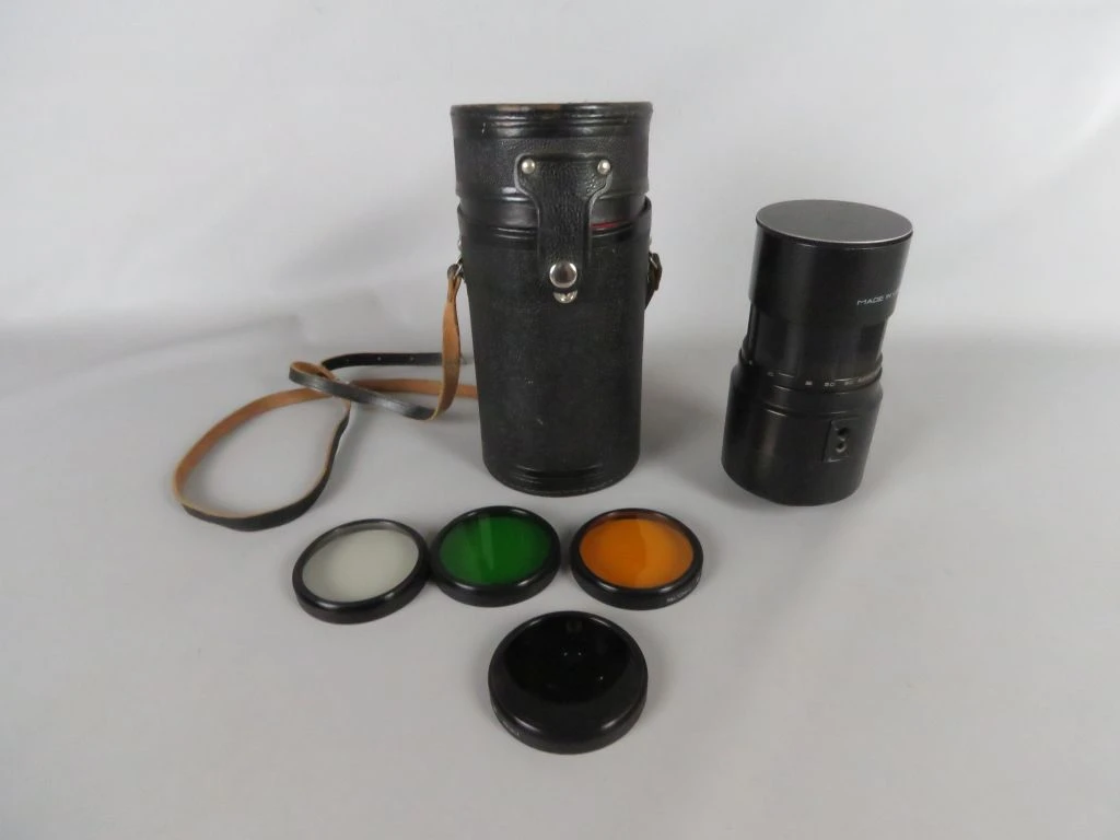 Vintage camera lens met filters en draagtas