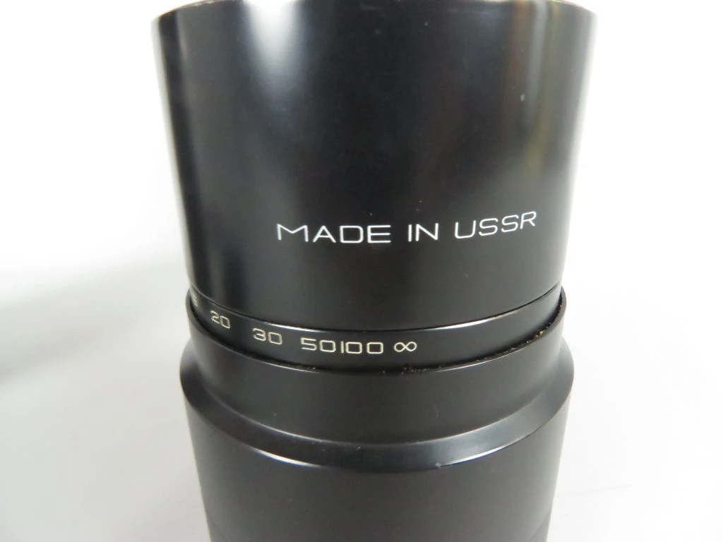 Vintage camera lens met filters en draagtas