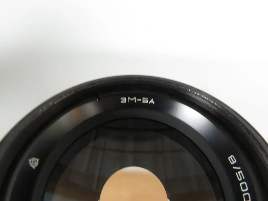 Vintage camera lens met filters en draagtas
