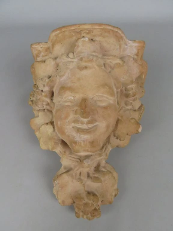 Decoratief stenen gevelornament met gezicht