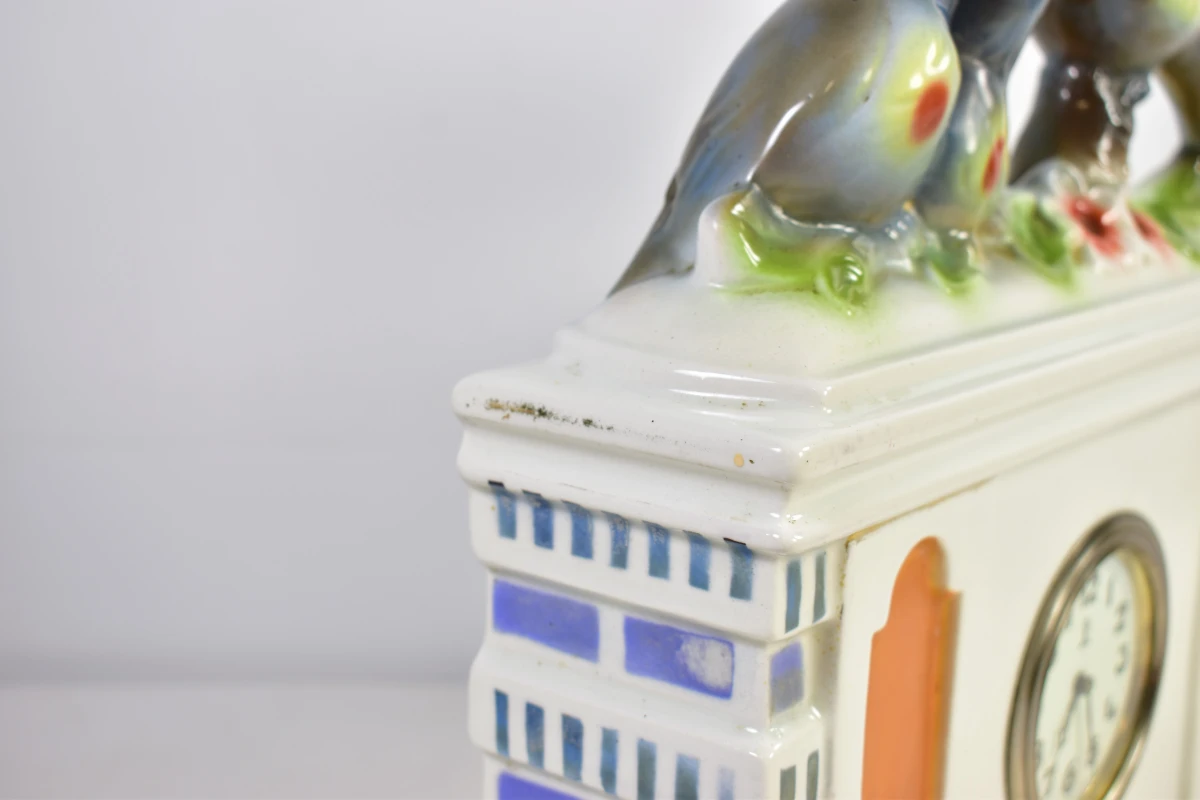 Vintage porseleinen klok met vogeldecoratie