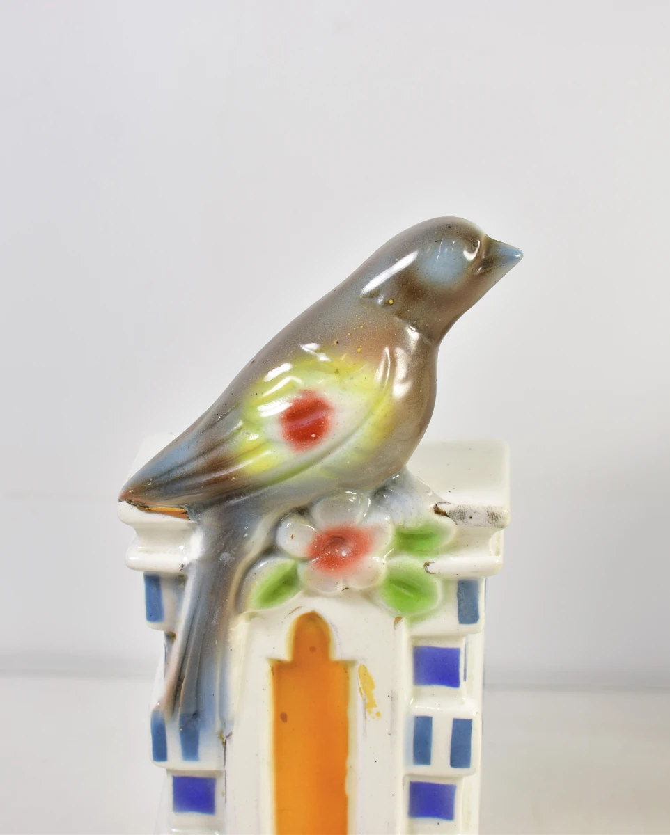 Vintage porseleinen klok met vogeldecoratie